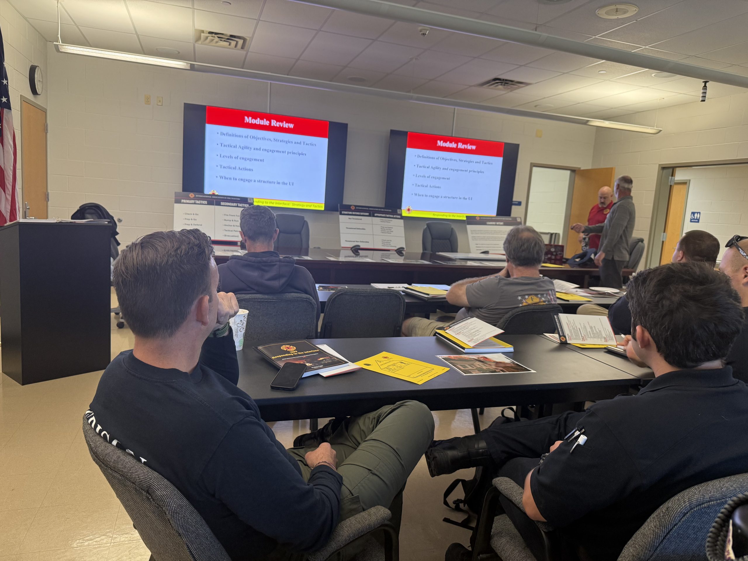Firefighters review classroom training material with instructors during the IAFF program.